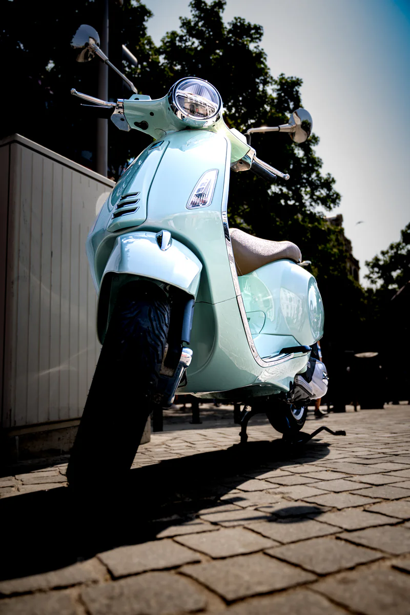 Light blue vintage scooter parked on cobblestone street in Porto (Helesinine retro skuuter Porto munakivitänaval)