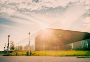 Estonian National Museum (ERM) building with dramatic sunrays through clouds (ERMi hoone Tartus, päiksekiired läbistavad pilvi)