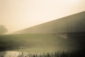 Angular modern building emerging from low morning fog (Struktuurne vaikus, valguse ja varju kombinatsioon) ERM