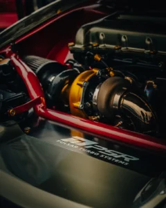 Modified engine bay with turbo and red rollcage at Augustfest 2025 (Jõuline inseneritöö – autofestivali fookus)