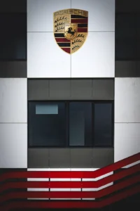 Porsche emblem on building facade at Augustfest 2025 (Autobrändi ikooniline visuaal)