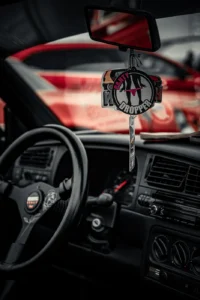Car interior with dreamcatcher hanging from rearview mirror (Subkultuurne ja isiklik autoportree)