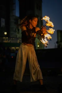 Street fire performance with female artist captivating audience in Porto