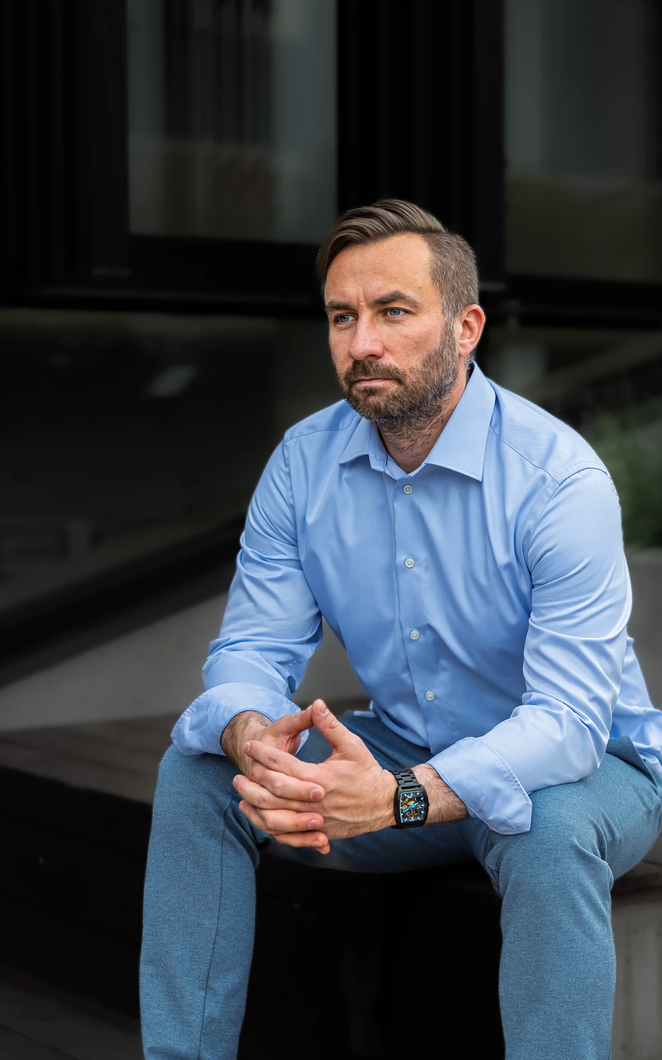 Anti Soosaar seated, hands together, looking away in contemplation (Anti istub käed koos, vaatab kõrvale mõtlikult)