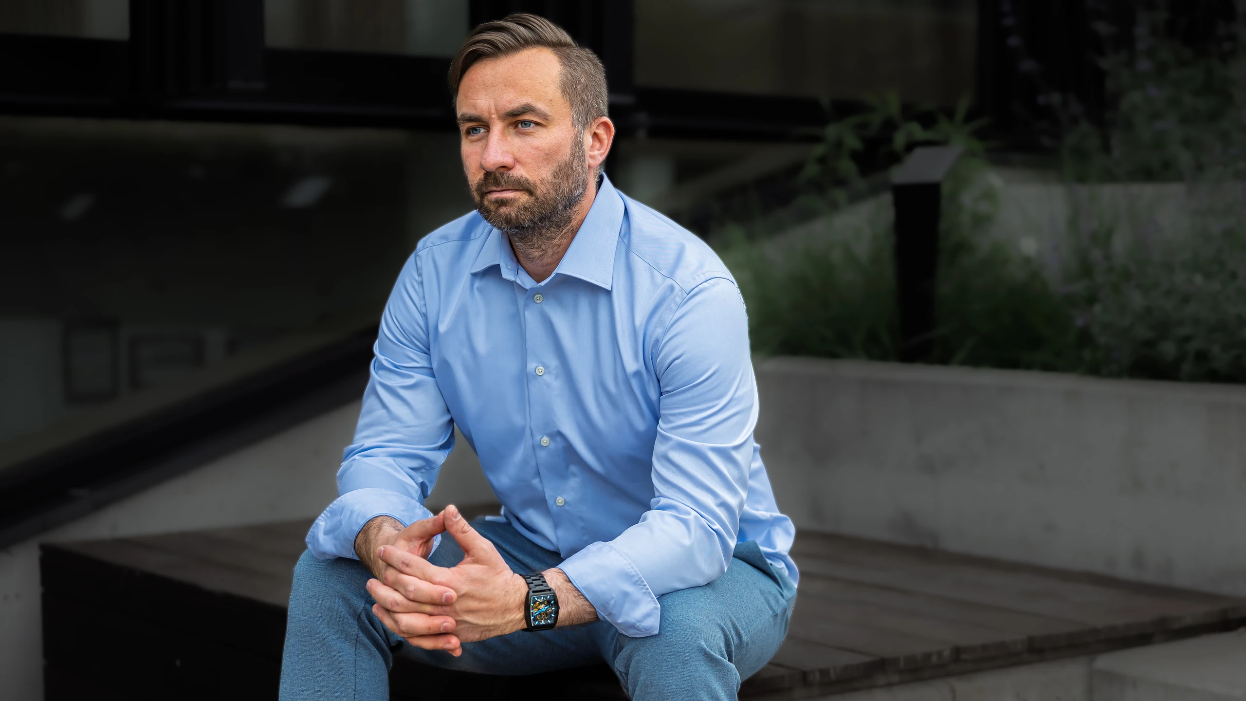 Anti Soosaar seated, hands together, looking away in contemplation (Anti istub käed koos, vaatab kõrvale mõtlikult)
