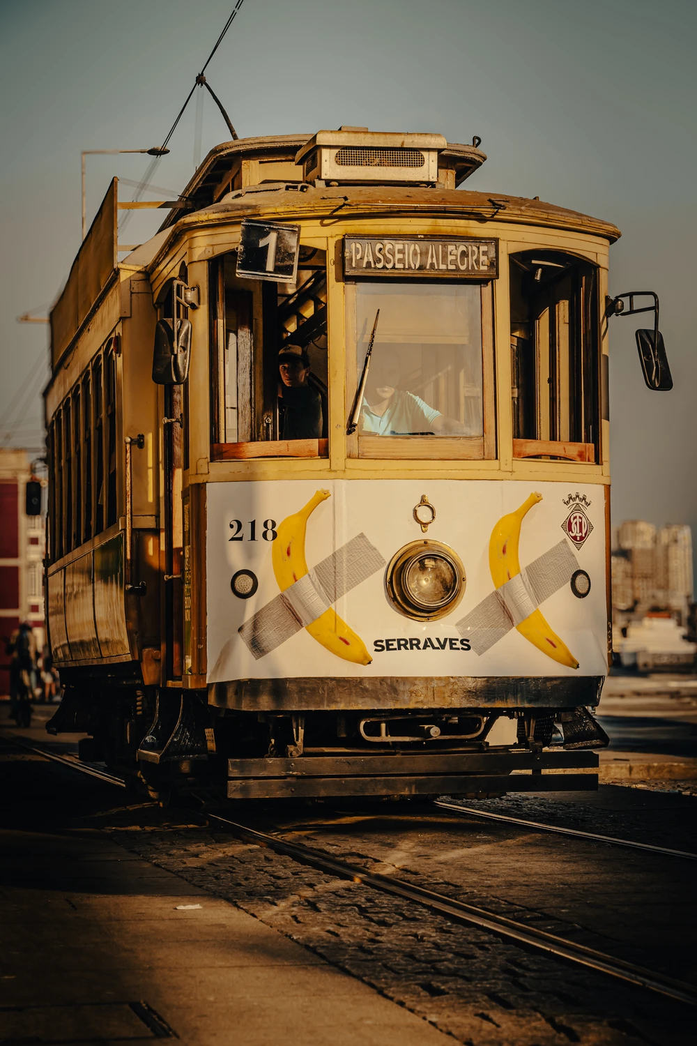 Classic yellow tram in Porto city street, urban transport detail